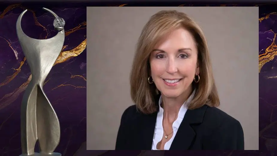 Professional headshot of Darlene Jones, CEO of the Society of St. Vincent de Paul Northeast Ohio, displayed alongside an award trophy against a purple and gold marble background.