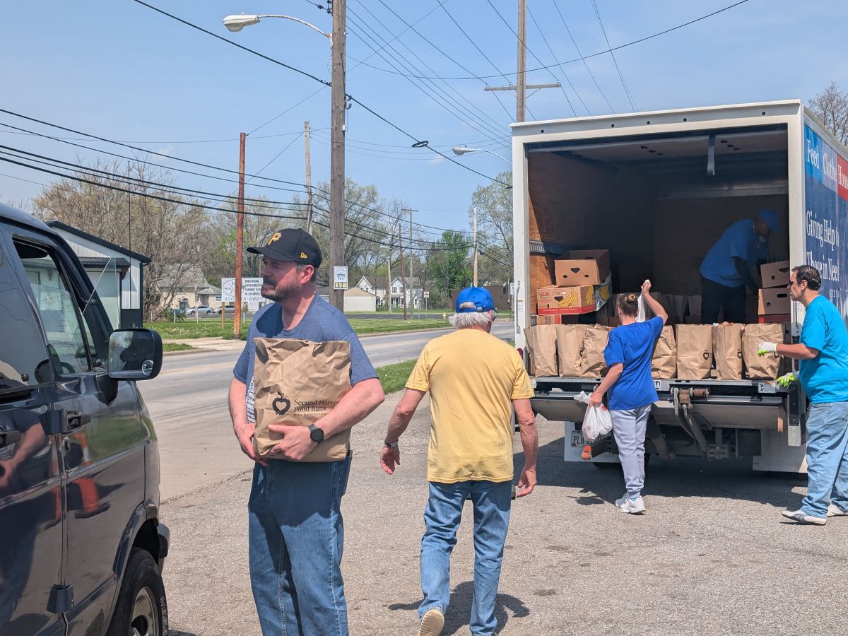 SVDP volunteers passing out bags of food