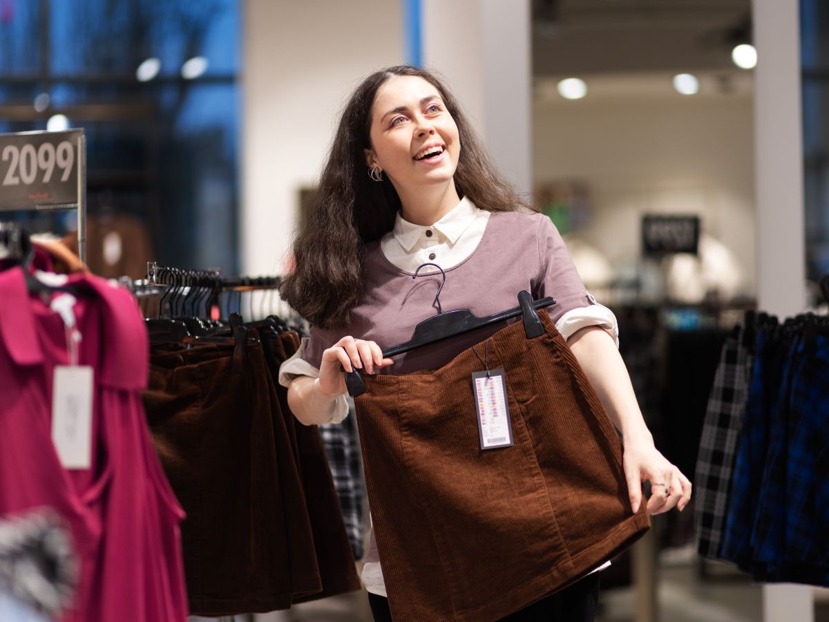 Woman holding skirt, smiling