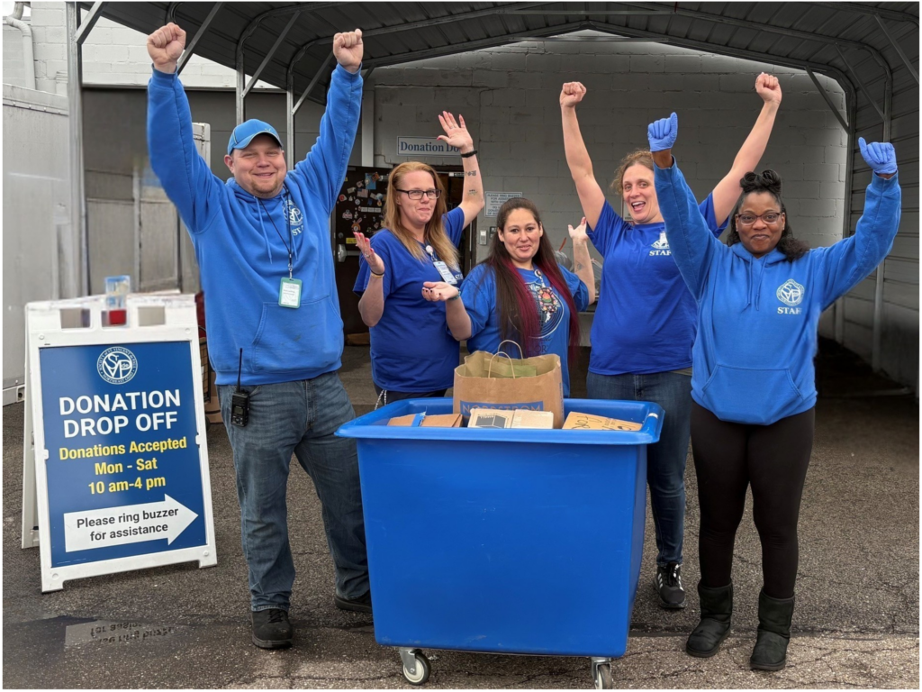 SVDP staff with arms up, celebrating