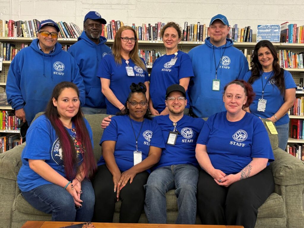 SVDP staff members in group photo at thrift store