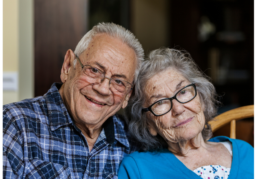 Senior couple wearing glasses smiling