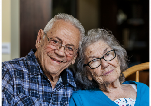 Senior couple wearing glasses smiling
